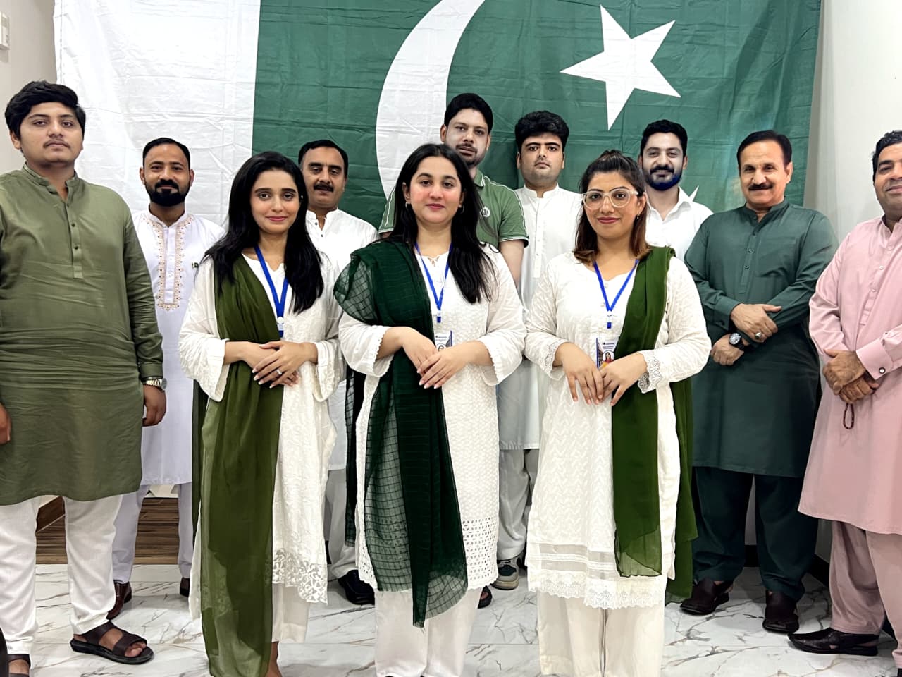 CPL Developers staff and management gathered before the Pakistan flag on Independence Day