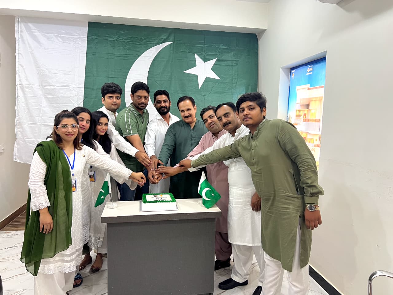 CPL Developers team cutting a 79th Independence Day cake